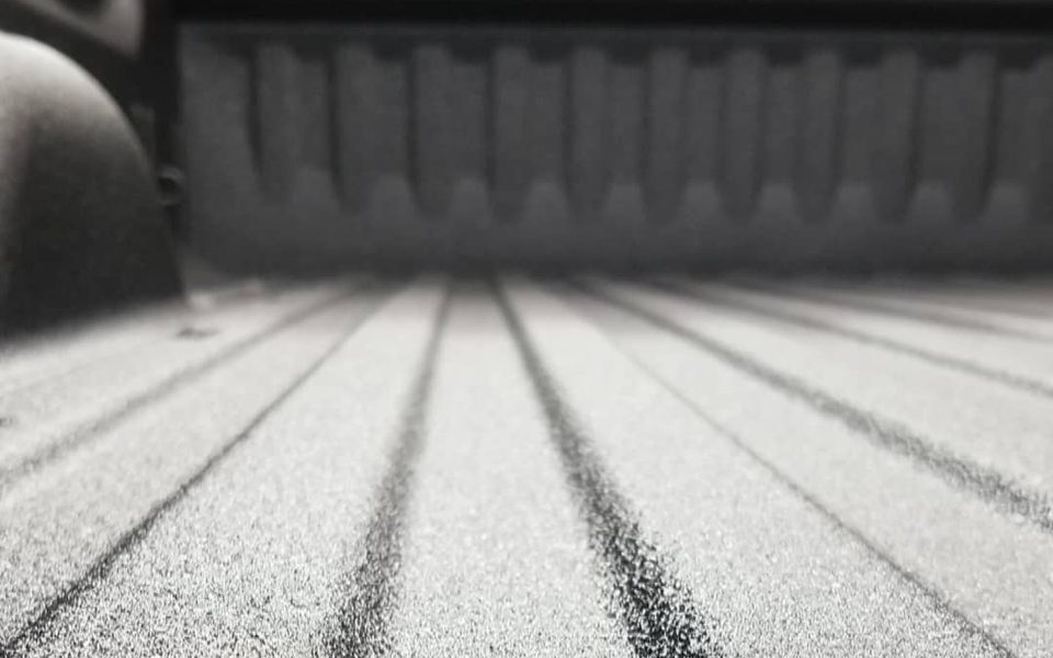 Spray-in bed liner in a truck bed