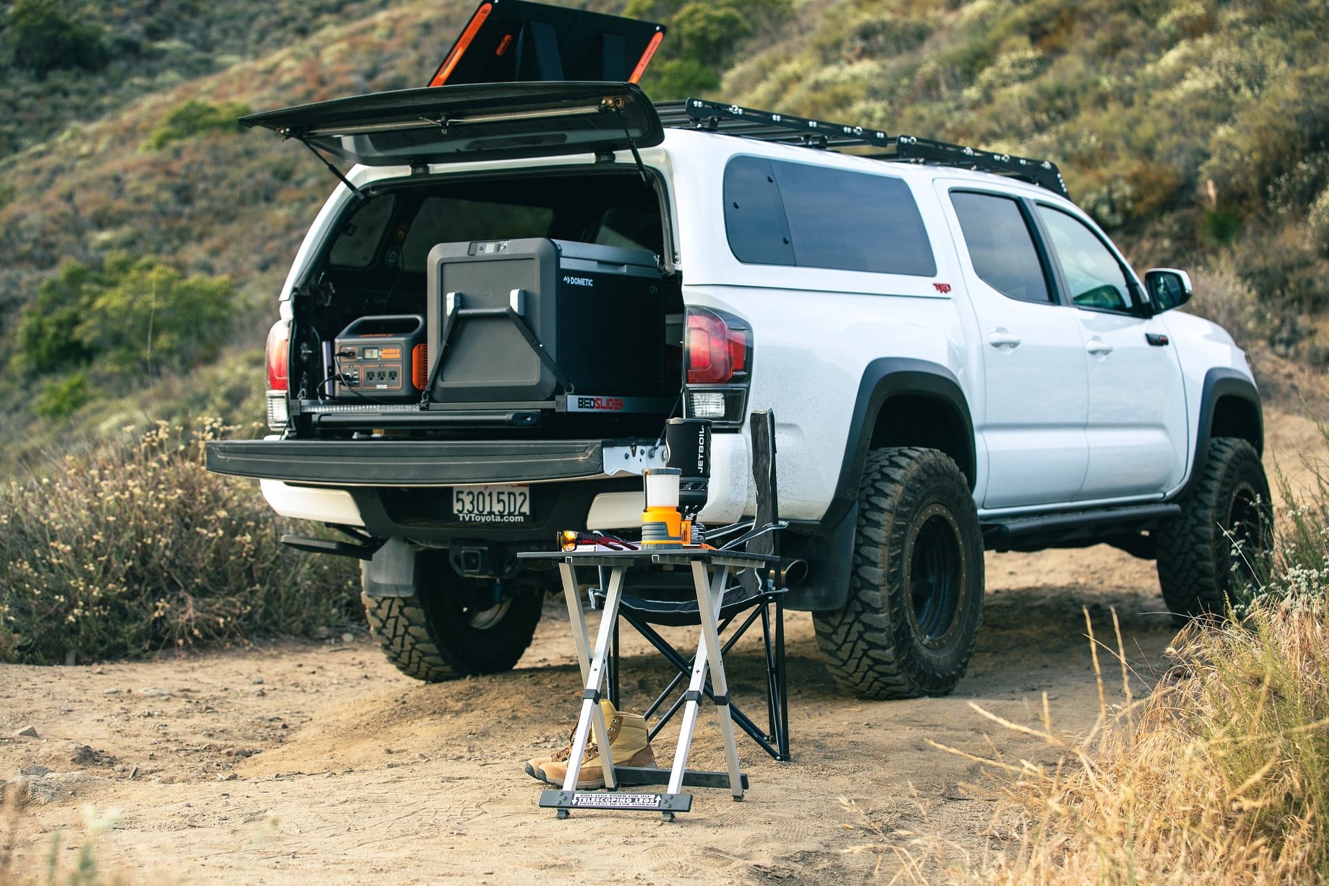 Truck with an A.R.E. topper and cargo setup